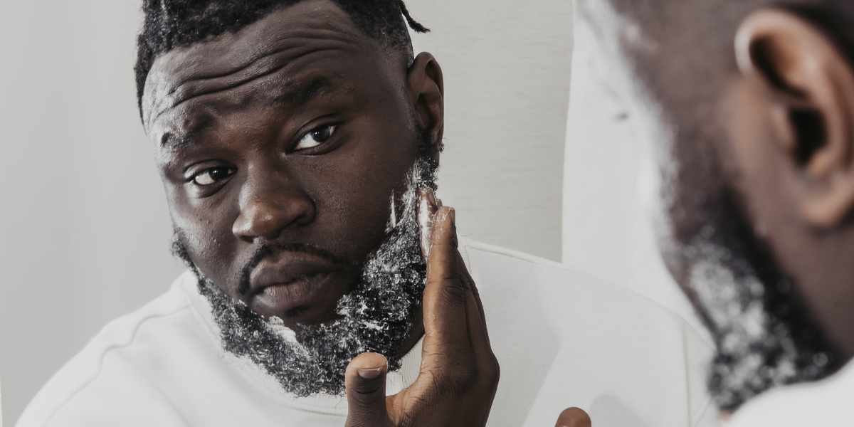 A guy hydrating his skin and beard