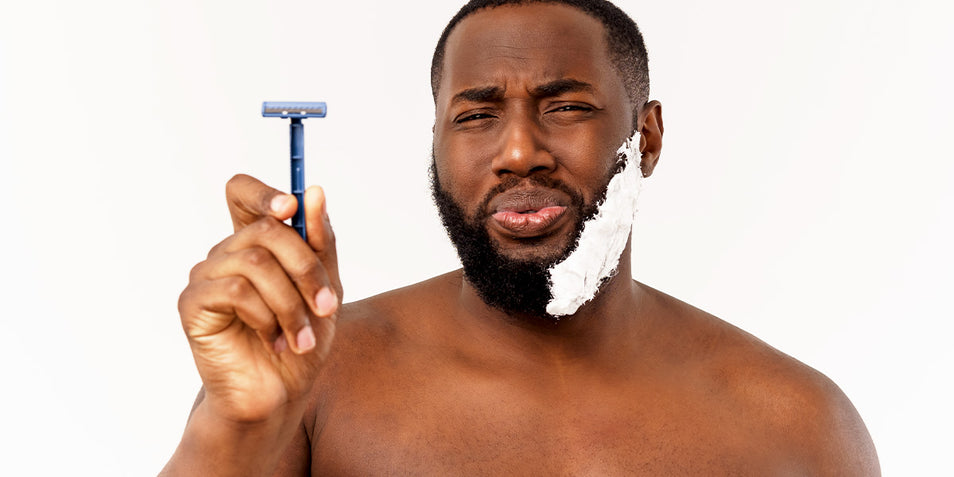 A man of color holding a razor