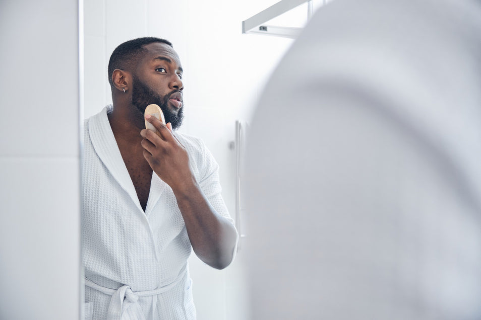 man using beard balm for his beautiful beard